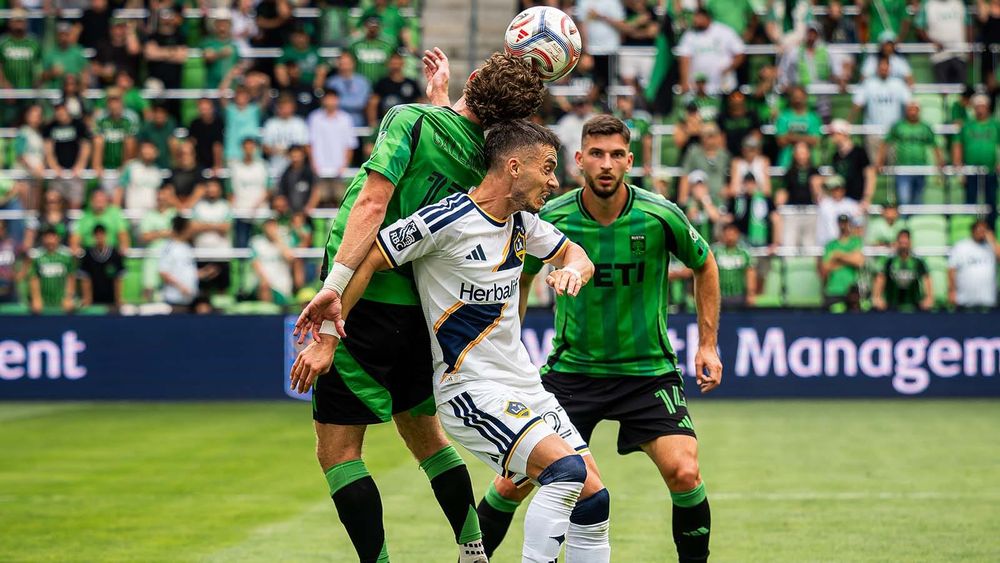 Jon Gallagher heading ball with LA Galaxy defender on his back