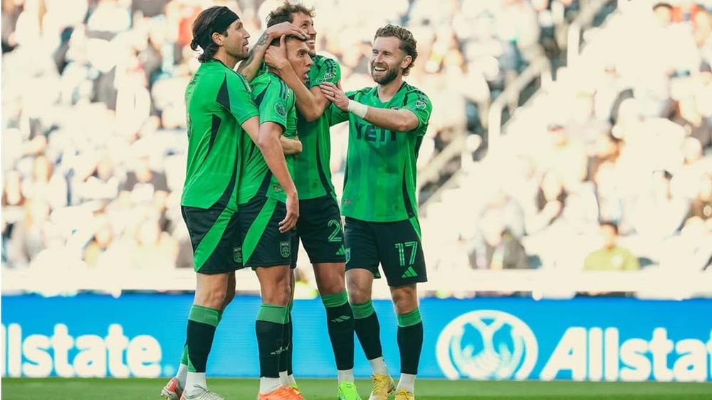 Myrto Uzuni hugged by teammates afer scoring a PK goal for Austin FC over Minnesota United FC