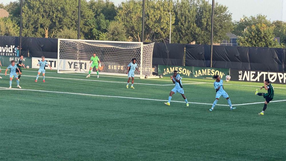 Austin FC II's Diego Abarca kicking a ball toward goal with Minnesota United FC 2 players defending goal