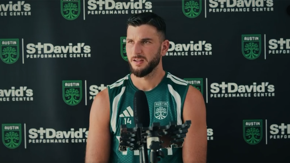 Austin FC's Besard Šabović in front of microphone at press conference