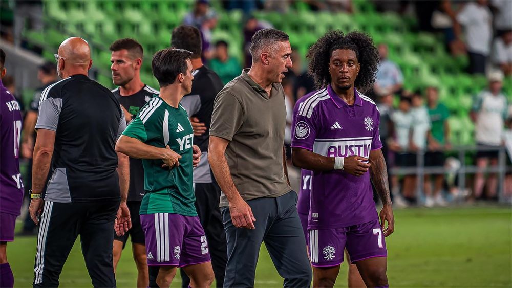 Austin FC interim head coach and winger Jayden Nelson talking on field after match