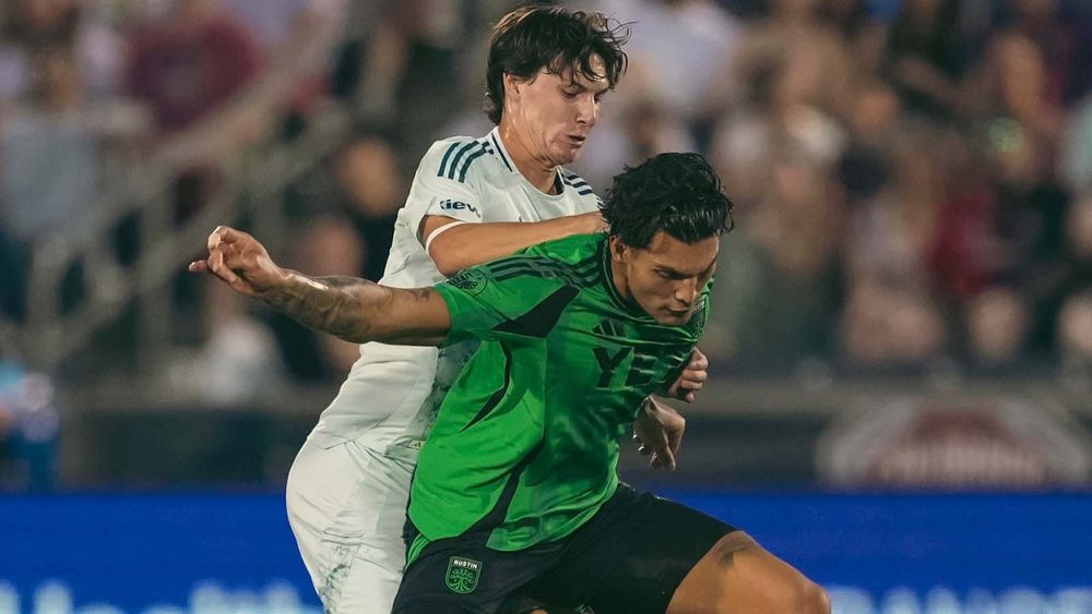 Austin FC's Brandon Vázquez being grappled by a Colorado Rapids player
