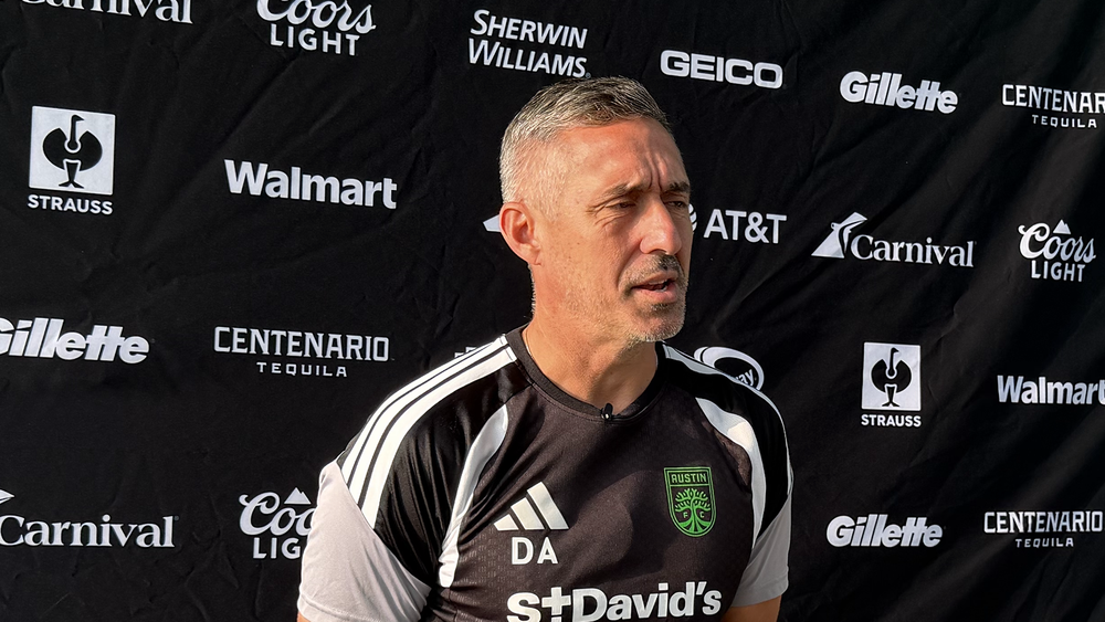 Austin FC head coach Davy Arnaud at a media availability for Leagues Cup (in front of a backdrop showing Leagues Cup sponsors