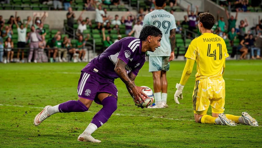 Austin FC's Facundo Torres picking up a ball and running with it after scoring against the Rapids 