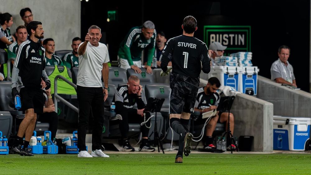 Austin FC interim head coach Davy Arnaud pointing and grimacing with Brad Stuver in the vicinity