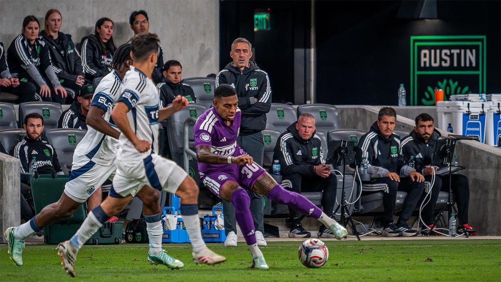 Davy Arnaud watches Joseph Rosales dribble the ball, guarded by two Vancouver defenders 