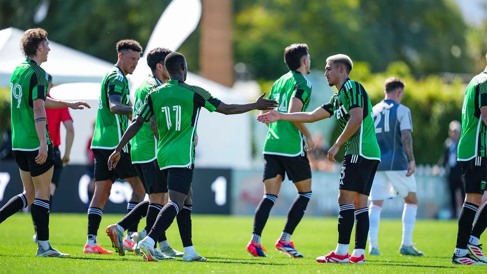 Osman Bukari and Owen Wolff low-five each other