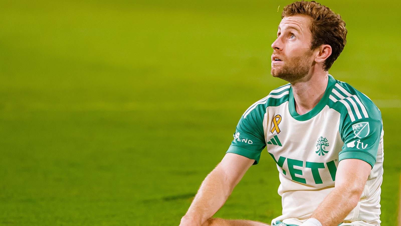 Jon Gallagher sitting on turf after Houston Dynamo FC scored on Austin FC