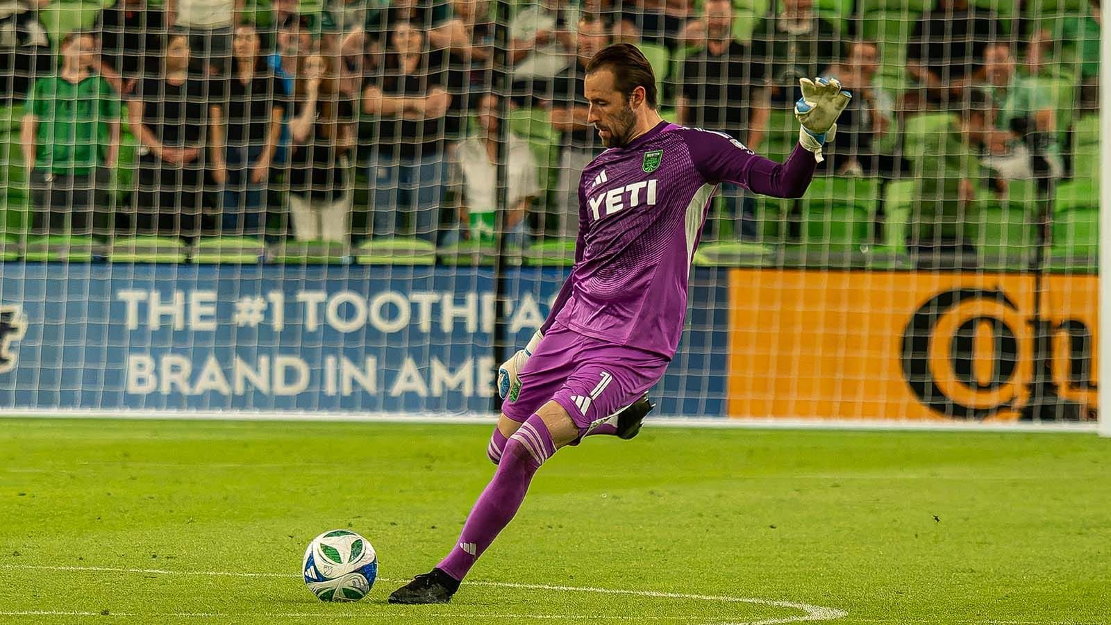 Austin FC goalkeeper Brad Stuver in purple jersey executing a goal kick