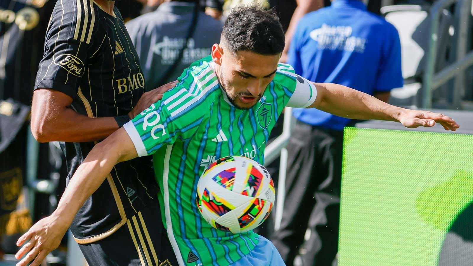 Cristian Roldan trapping the soccer ball with his body during a match
