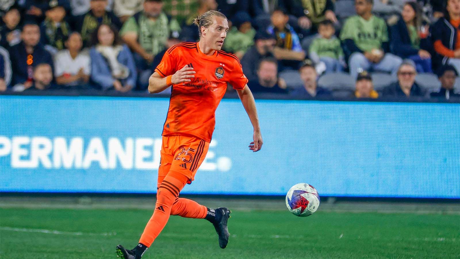 Griffin Dorsey of Houston Dynamo FC playing in a match, trying to control a ball
