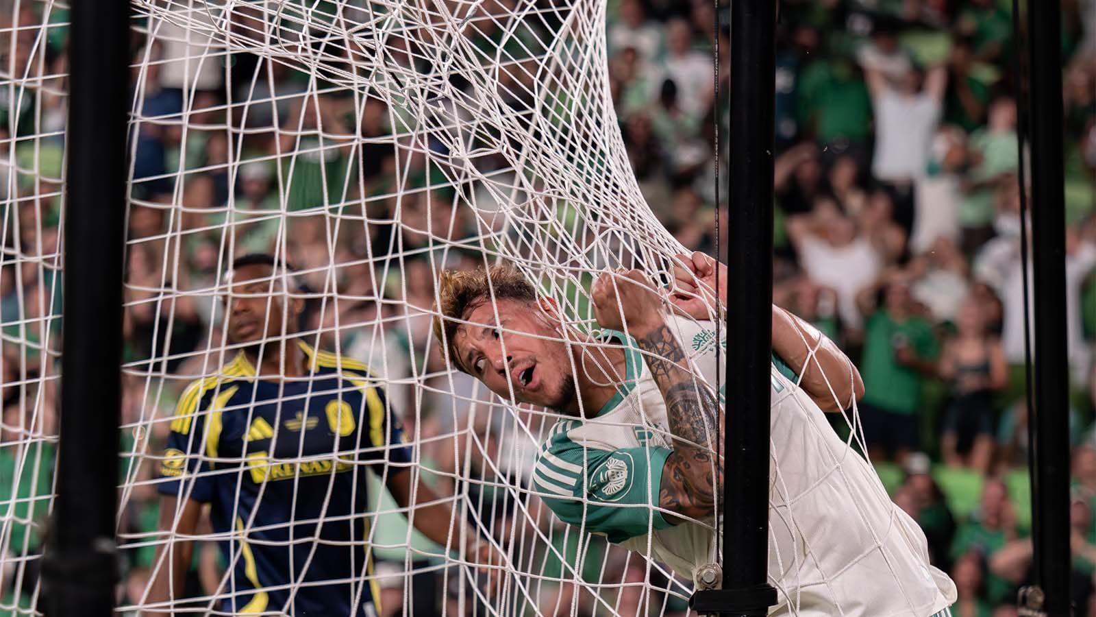 Guilherme Biro tangled in goal net