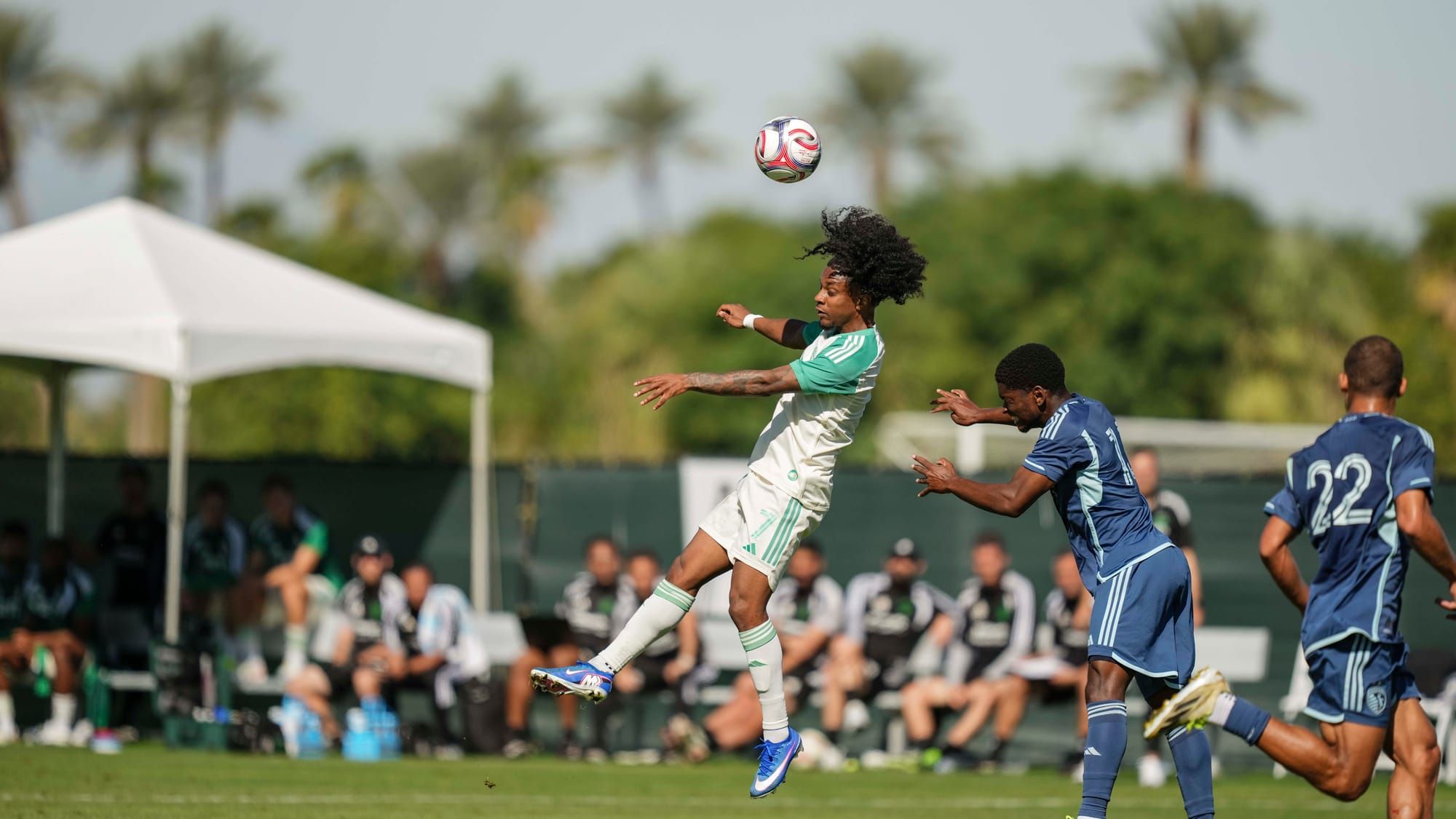 Jayden Nelson heading a ball in a Coachella preseason match against Sporting Kansas City