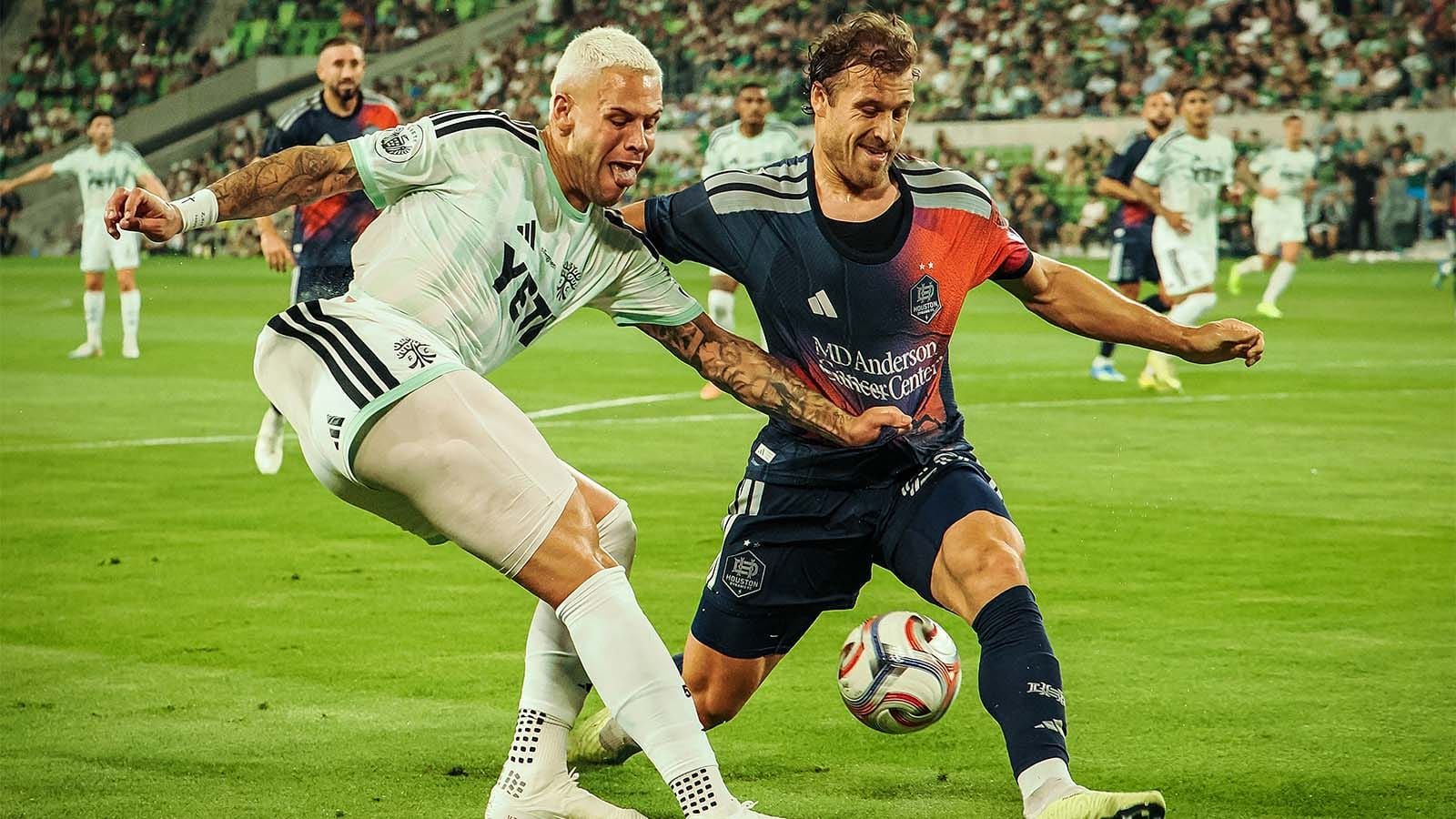 Austin FC's Christian Ramirez fighting for ball with Houston Dynamo defender