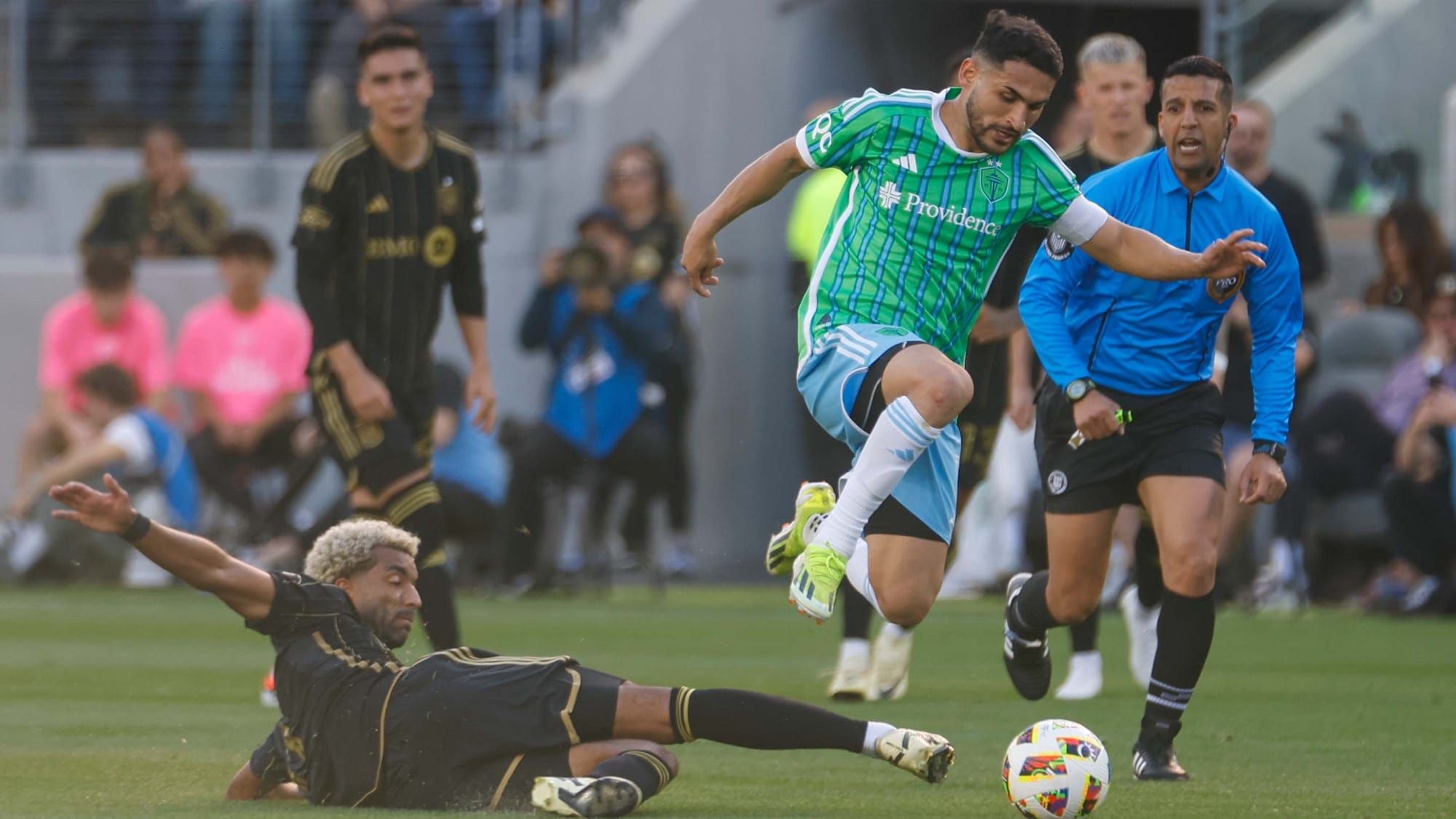 Seattle Sounders FC's Cristian Roldan evading a tackle from Timothy Tillman