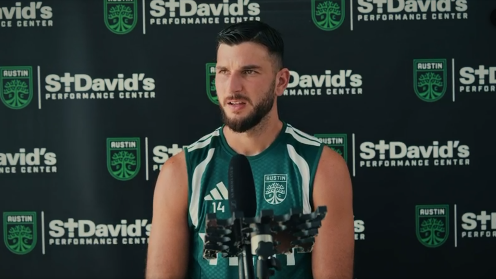 Austin FC's Besard Šabović in front of microphone at press conference