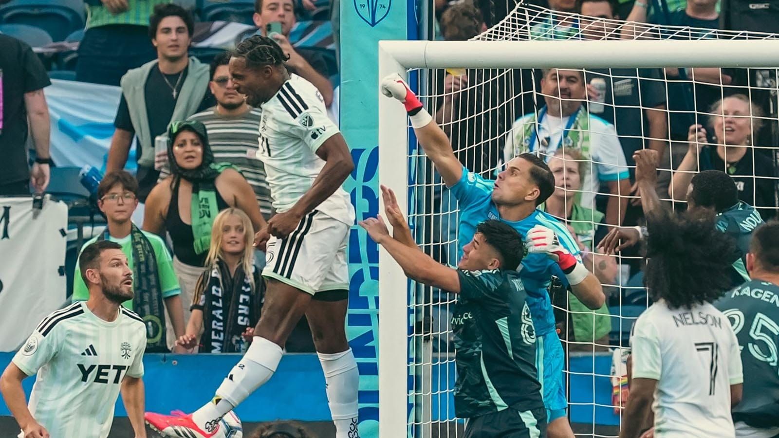Austin FC and Seattle Sounders FC players battling in front of goal