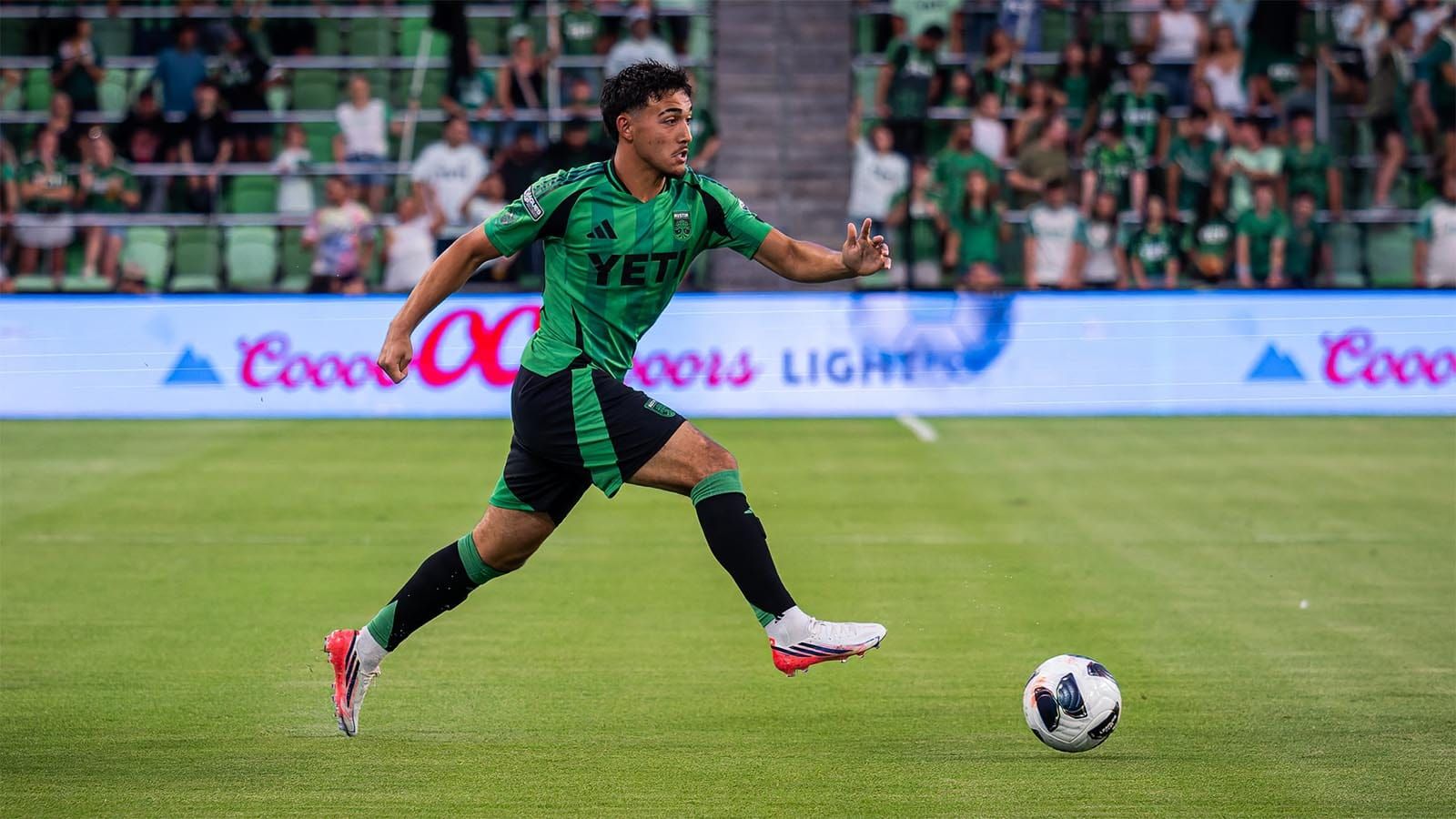 Owen Wolff dribbling ball downfield