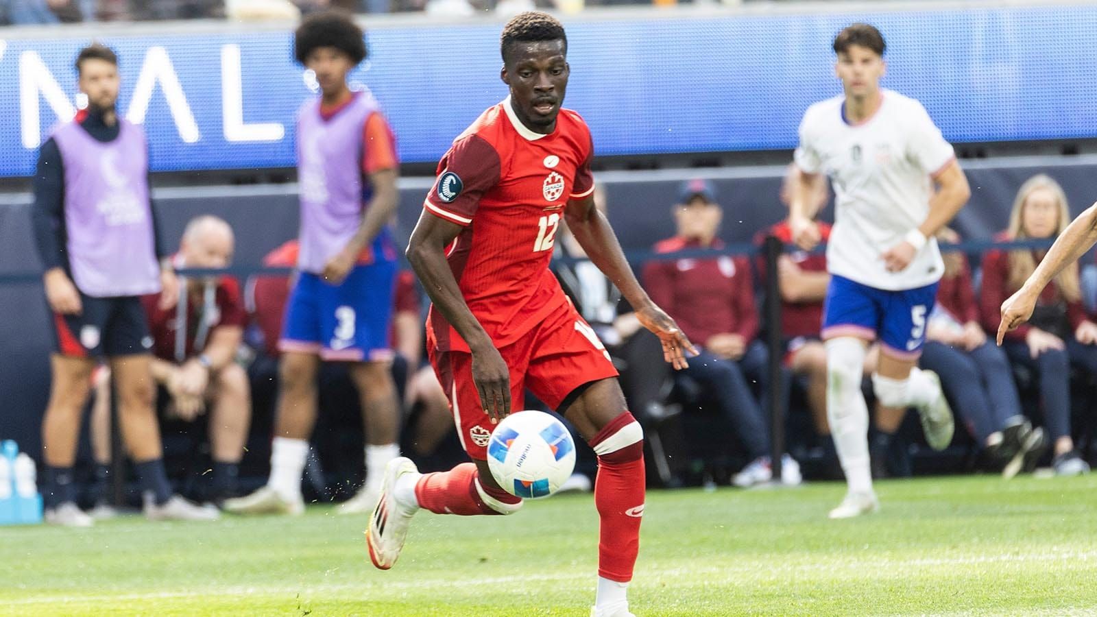 Tani Oluwaseyi playing a soccer match with Canada