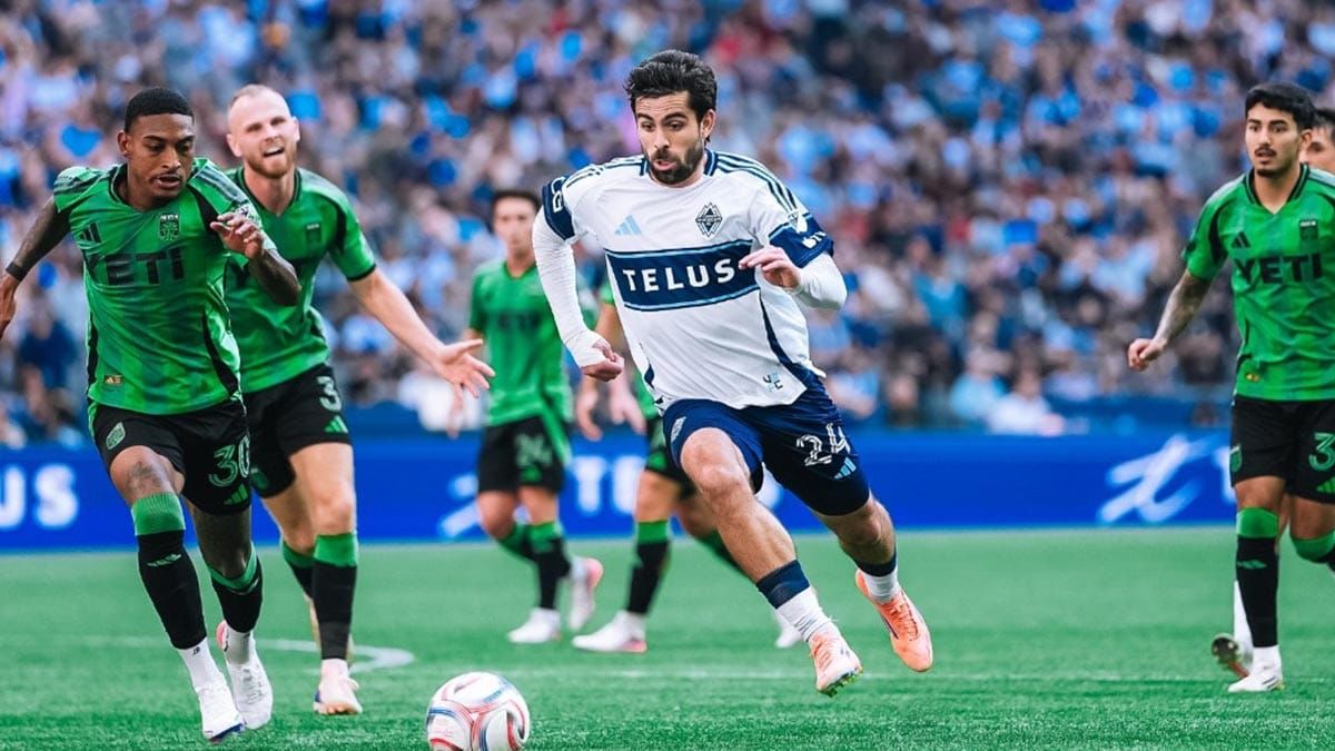 Vancouver's Brian White advancing the ball, surrounded by Austin FC defenders