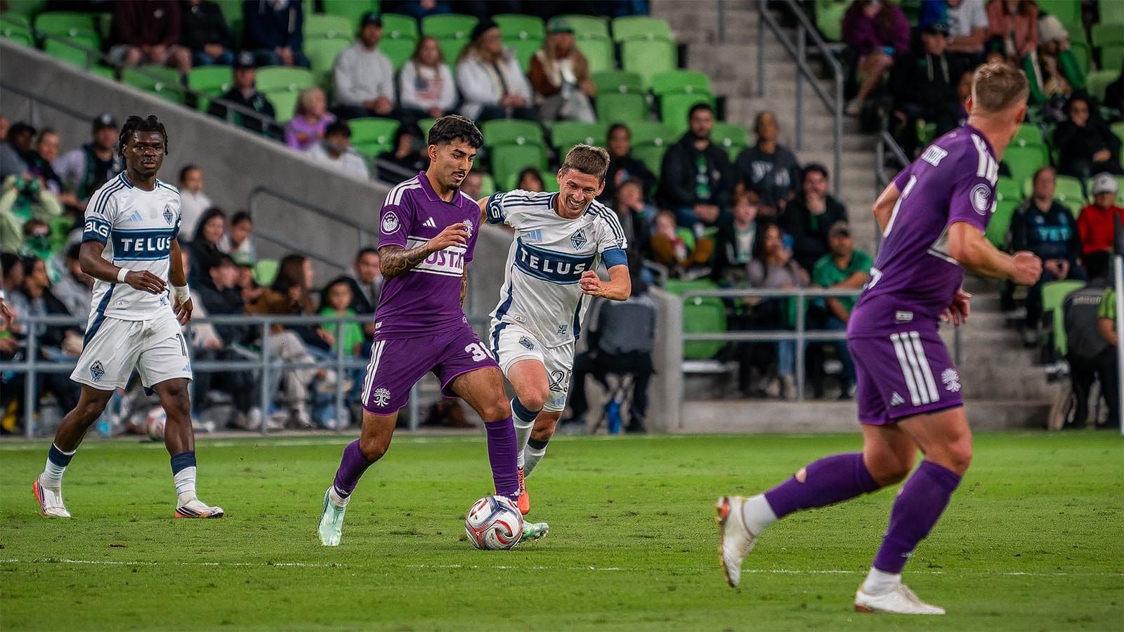 Austin FC's Ervin Torres, pursued by Vancouver Whitecaps FC's Ryan Gauld 