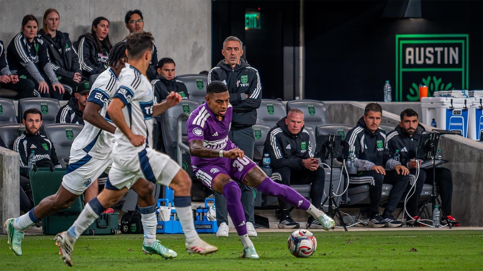 Davy Arnaud watches Joseph Rosales dribble the ball, guarded by two Vancouver defenders 