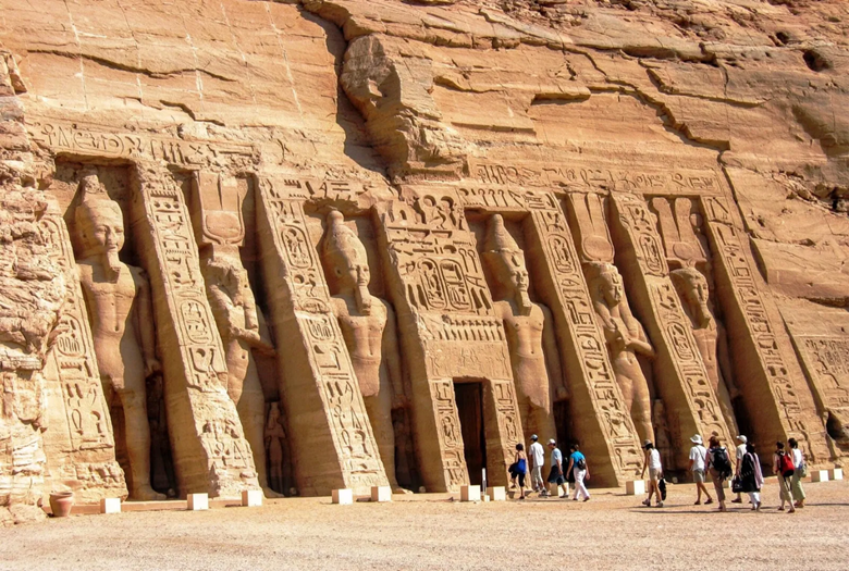 The entrance to the temple is a small door, flanked by high relief statutes of the pharoah and various gods and buttresses carved with hieroglyphics.  image is from Britannica