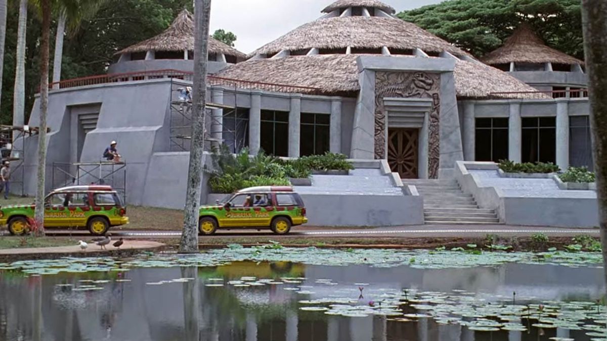 Shot of the visitor's center from Jurassic Park (1993). The building is in the background, with two Ford Explorers with the Jurassic Park livery in the left foreground.