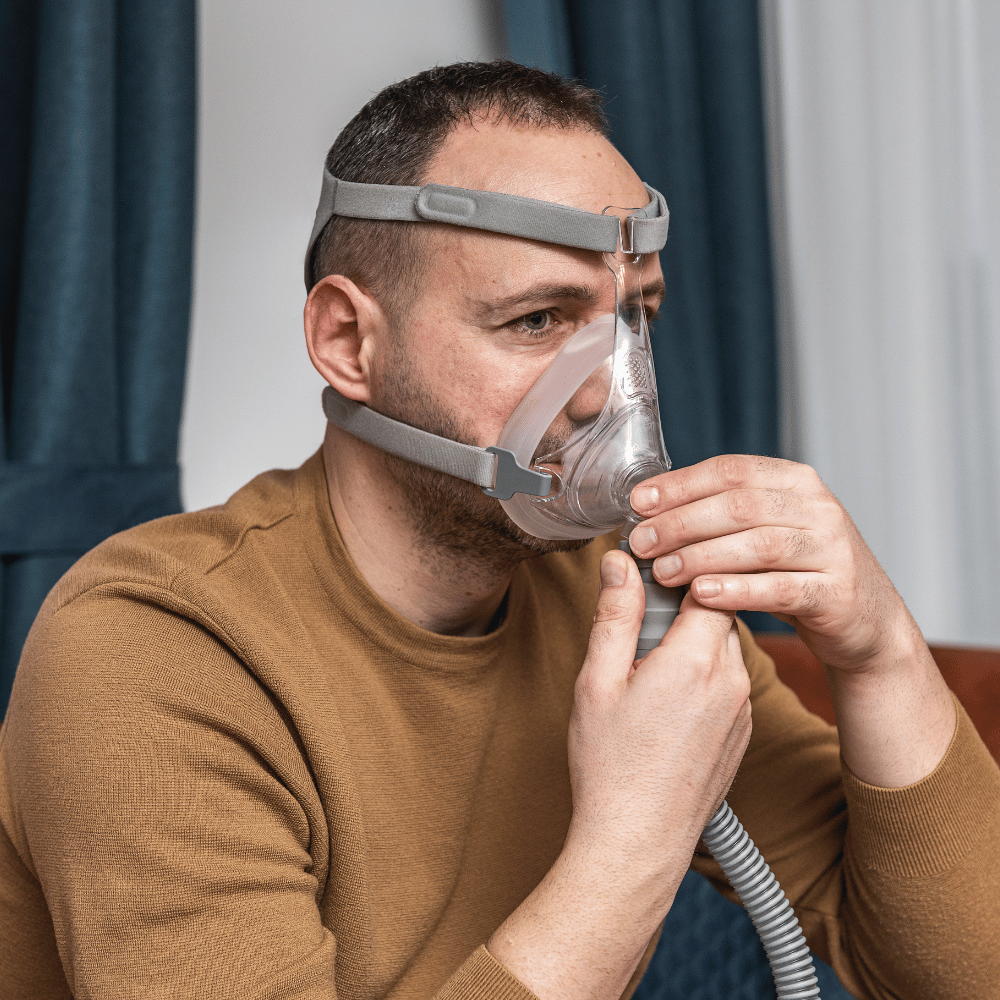 Man fitting full face CPAP