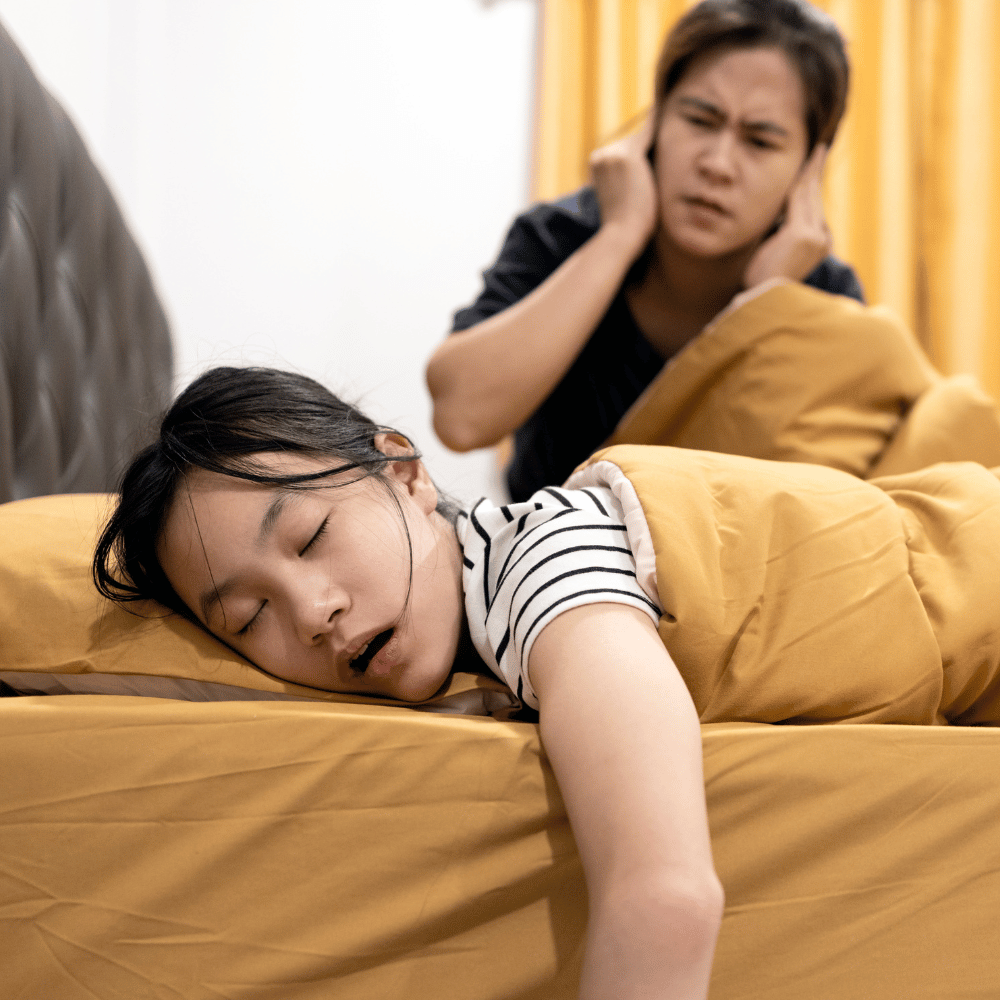 Woman snoring loudly, partner annoyed