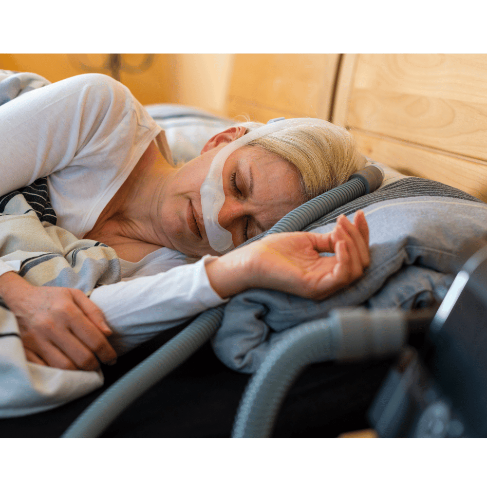 Woman sleeping using nasal CPAP