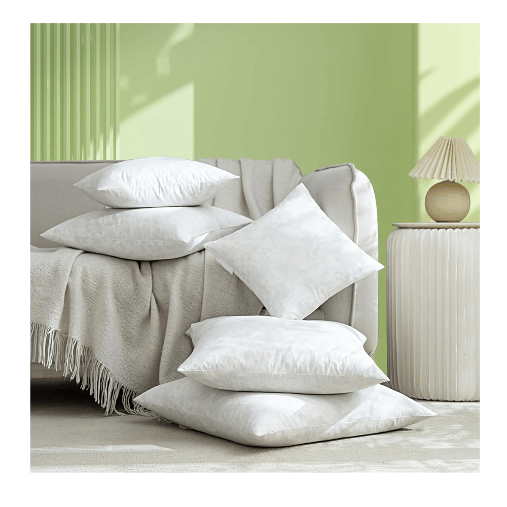 stacked feather throw pillow inserts on neutral sofa for living room décor layering (C: Dorrin Nessin/Amazon)