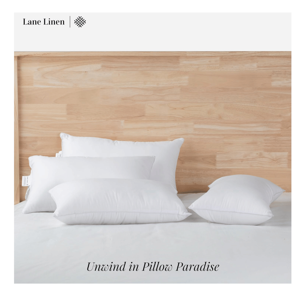 lane linen pillows arranged on wood headboard bed promoting breathable hotel style comfort (C: Lane Linen/Amazon)