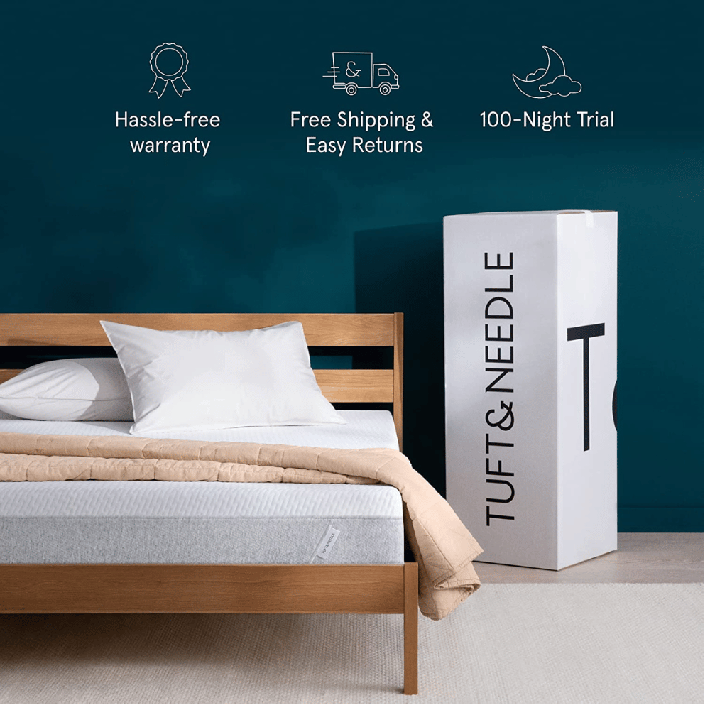 tuft and needle bed in a box beside wooden bed frame with teal wall
