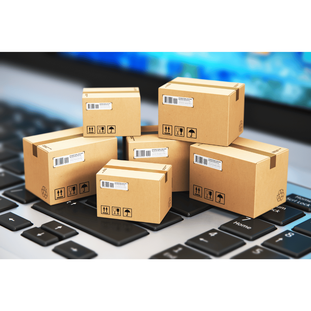 small shipping boxes on laptop keyboard representing online mattress delivery