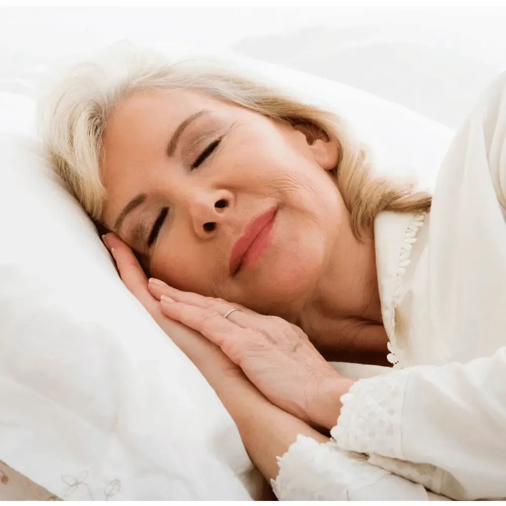Elderly woman resting peacefully on pillow