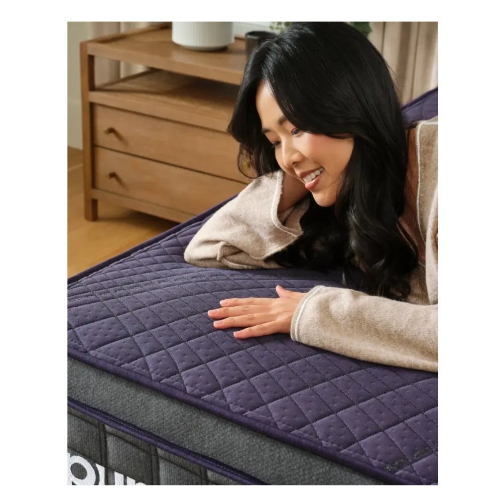 Woman testing Purple mattress surface