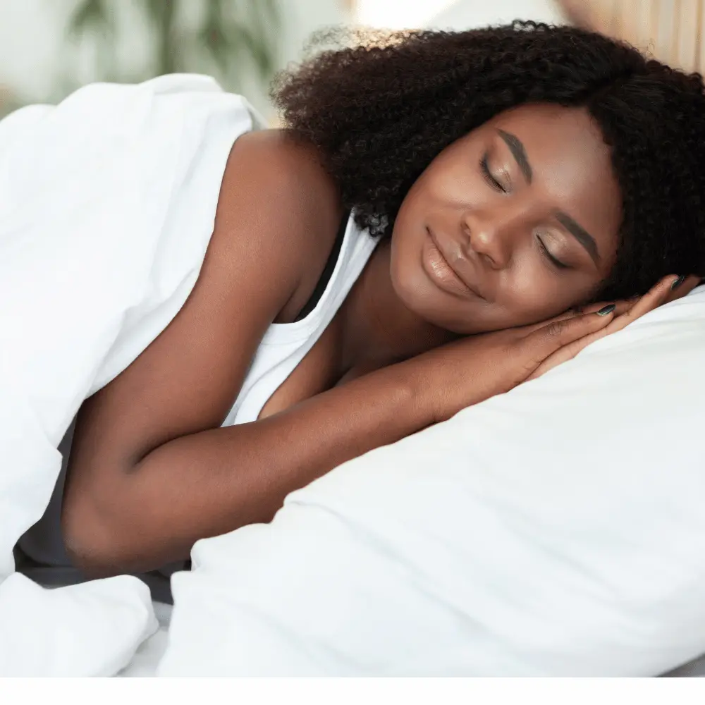 Smiling woman resting cozily at night