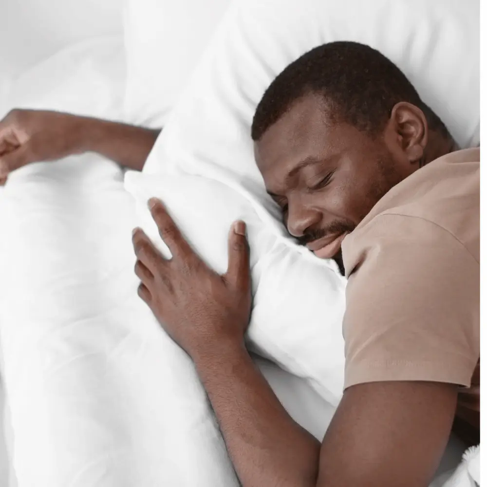 Man sleeping white pillows