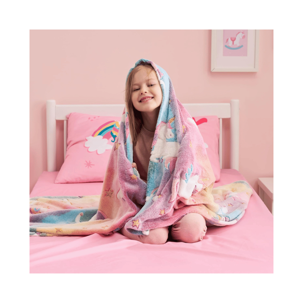 Girl with unicorn glow blanket