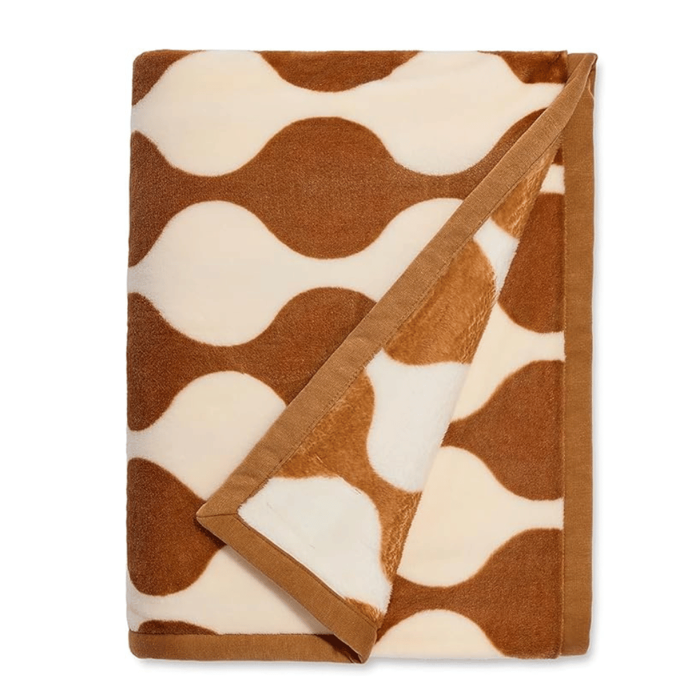 UGG Ariana Blanket in reversible tan and ivory pattern folded neatly (Credit: UGG / Amazon)