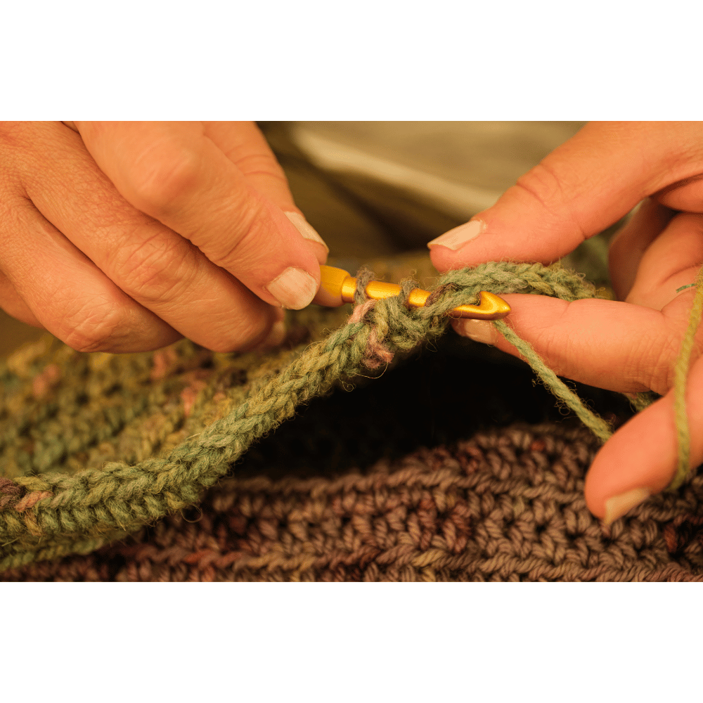 hands crocheting blanket