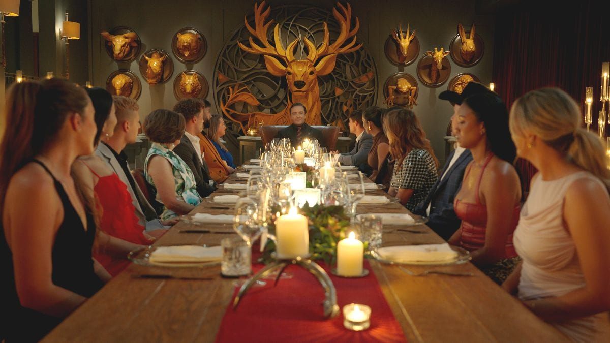 The Million Dollar Secret season 2 cast sits at dinner with host Peter Serafinowicz. (Photo Credit: Courtesy of Netflix.)