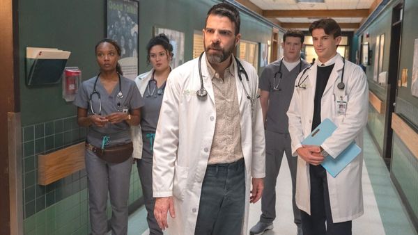Zachary Quinto as Dr. Oliver Wolf stands in a hospital hallway with his team in a scene from the Brilliant Minds Season 2 premiere. (Photo Credit: Courtesy of NBC.)