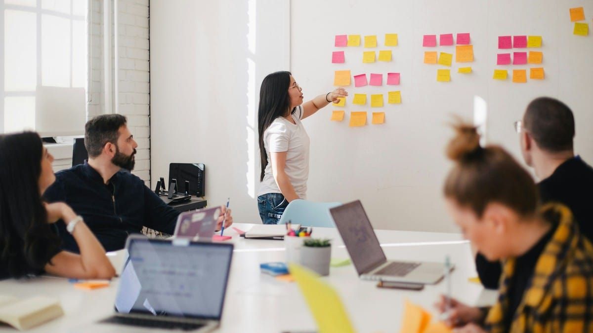 Team mapping conversation themes on sticky notes for ChatGPT Ads context hints