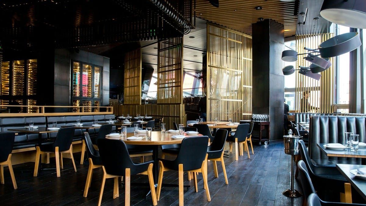 Warm cafe interior with wooden tables and hanging lights, no text overlay
