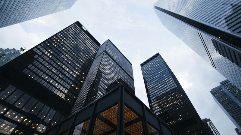 Cool-toned glass skyscraper city skyline, editorial photo, no text overlay