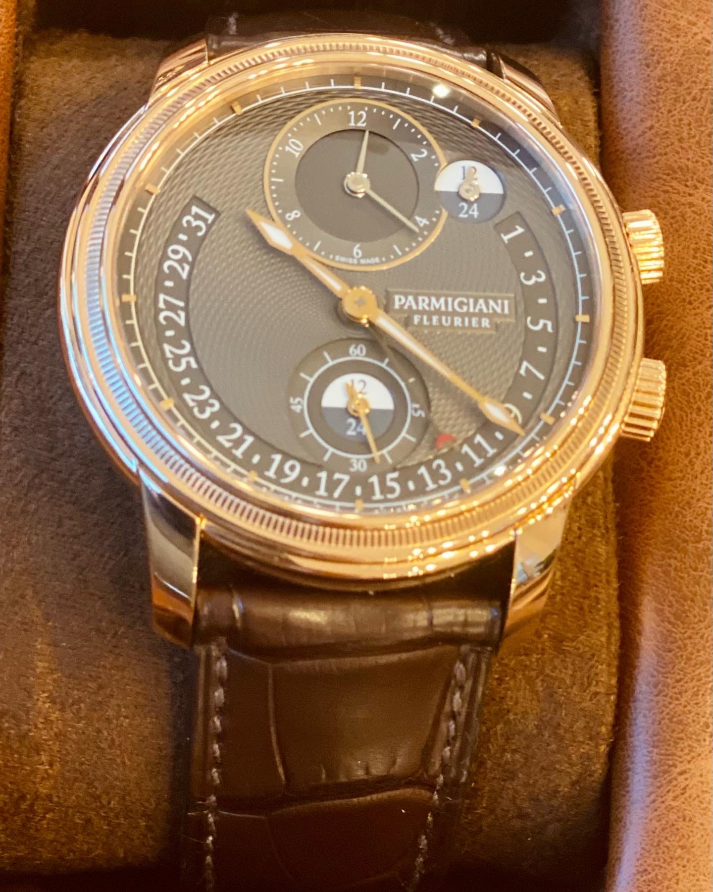 Close view of the dark guilloché dial, knurled bezel and rose-gold case of the Parmigiani Fleurier Toric.