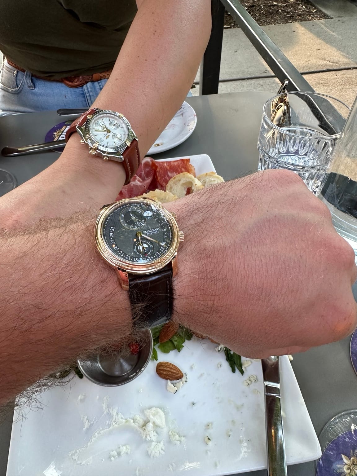 The rose-gold Parmigiani Fleurier Toric worn on the owner’s wrist during an outdoor meal.