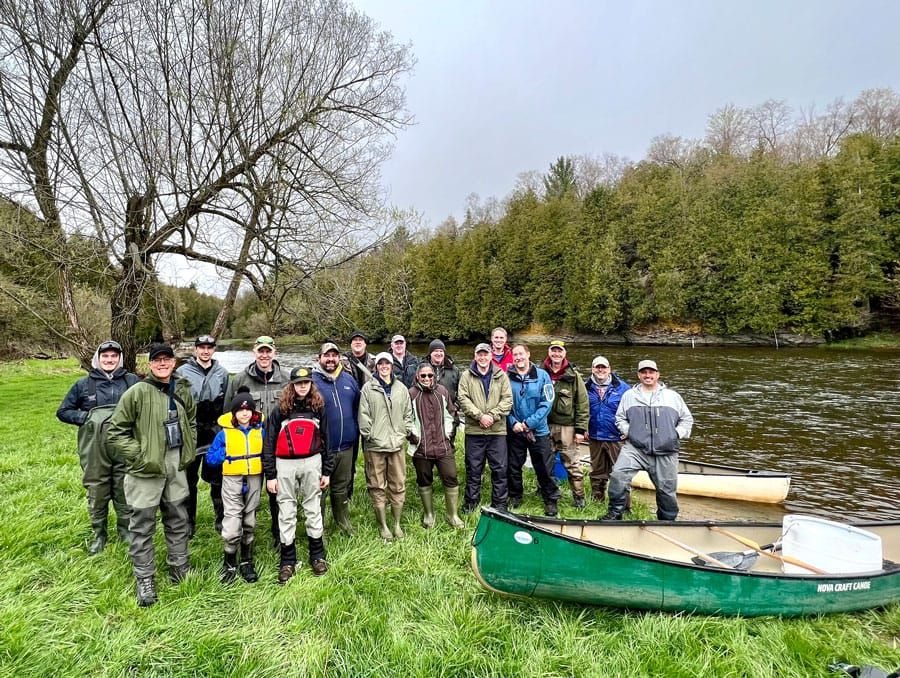 Volunteers stock the Grand River with 16,000 brown trout post image